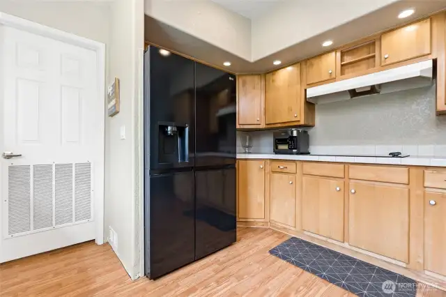 Range and fridge placement with door to the laundry/mud room.