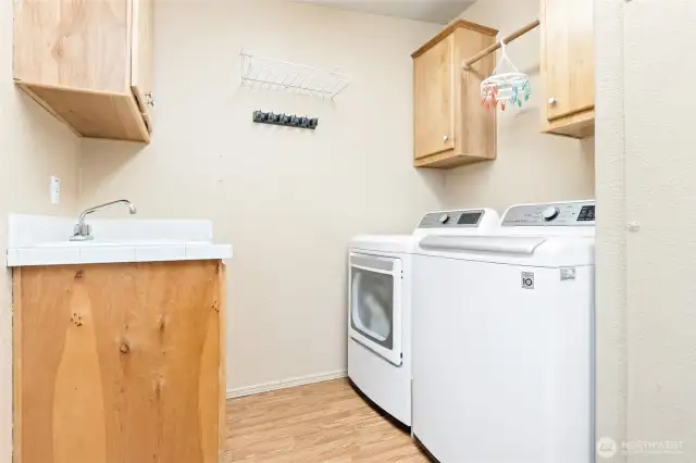 Very functional laundry room/mud room with a door to access the backyard.