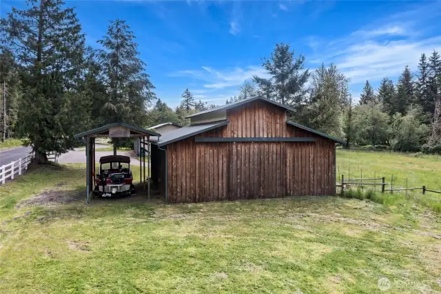 Backside of the barn with covered RV/boat parking.