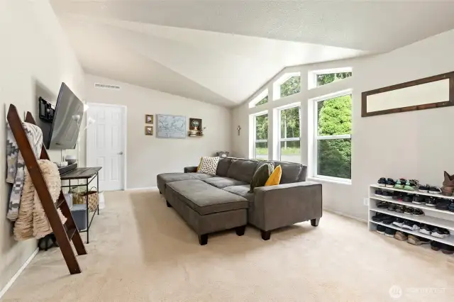 Living room with primary bedroom door on the far wall.