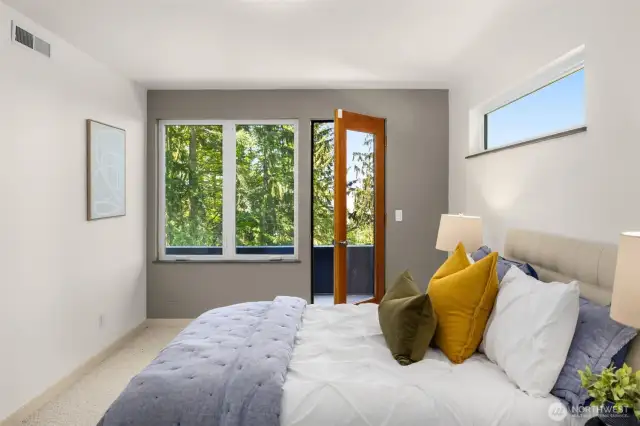 The first of 2 guest bedrooms on the same level as the primary bedroom.  The deck is shared by the 2 guest bedrooms.  This room also features a walk-in closet.