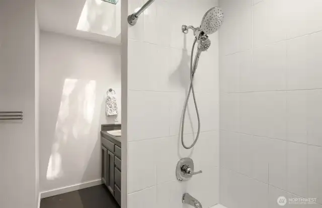 The guest bathroom was just recently refreshed with a new bathtub, fixtures, and a tile surround.