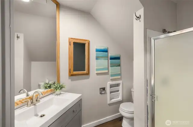 The lower-level offers a 3/4 bathroom with a recently updated vanity & LVP flooring.