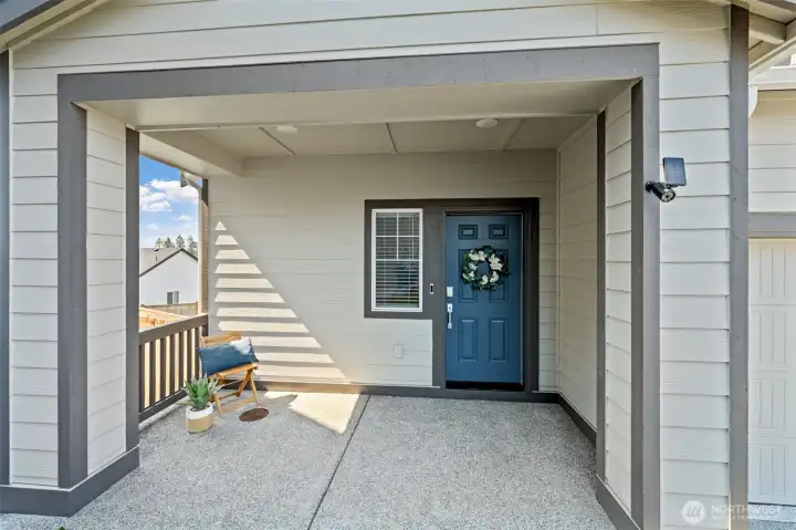 Large, usable front porch secluded by lovely landscaping.