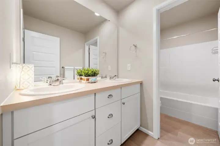 Upstairs hall bath with a door to the toilet and shower.
