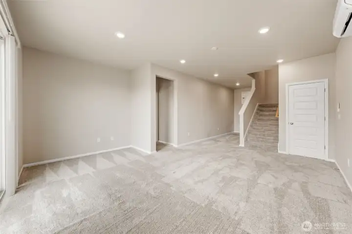 Basement level suite with 9' ceilings. This is the family room and desk area next to the stairway. A closet door to the right of the stairs.