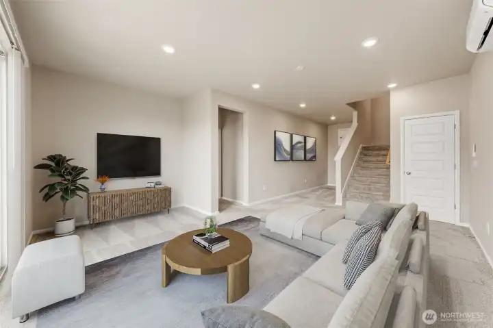 Basement family room with virtual staging. There is a sliding glass door to the patio.