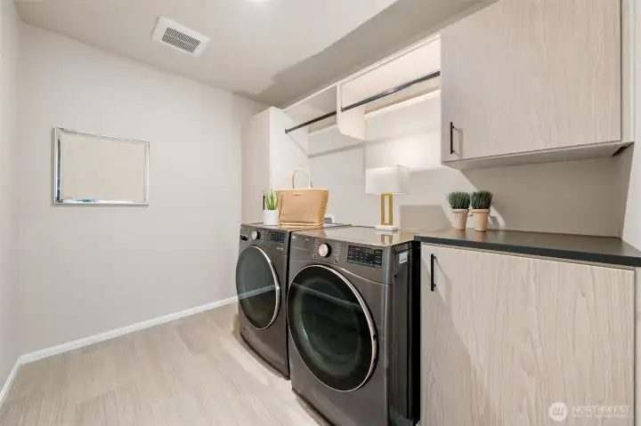 Laundry room with entensive cabinetry.