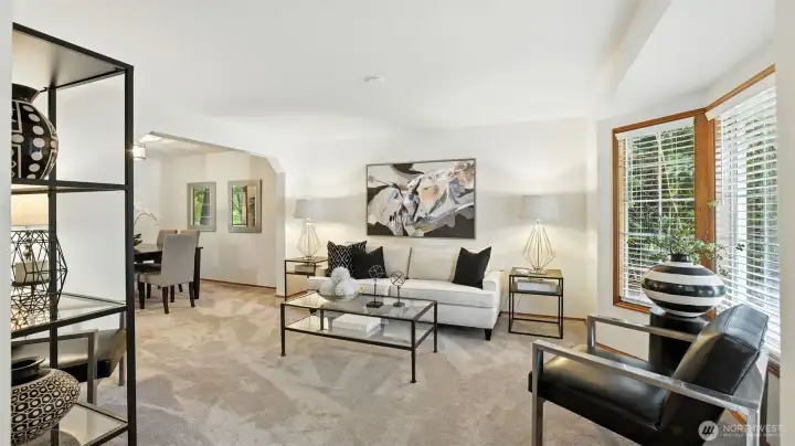 The inviting living room offers a bay window with views into the front yard