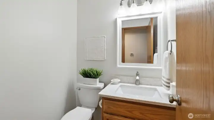 The powder room features a quartz counter