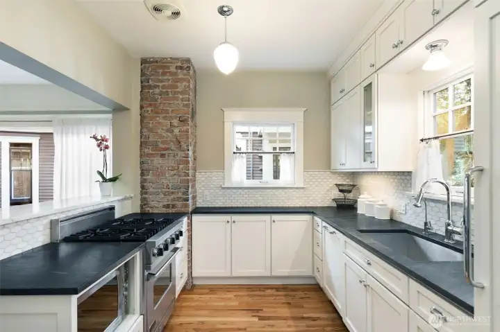 This kitchen is beautiful and functional. The U shape design makes a perfect triangle work space with the gas range on one side, and the sink and fridge on the opposite side.