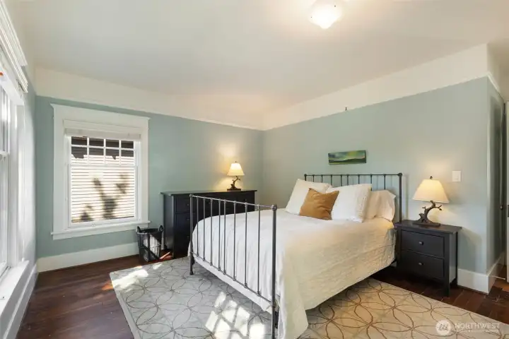 The Primary bedroom is large enough for a Kind bed as well as a dresser and side tales.