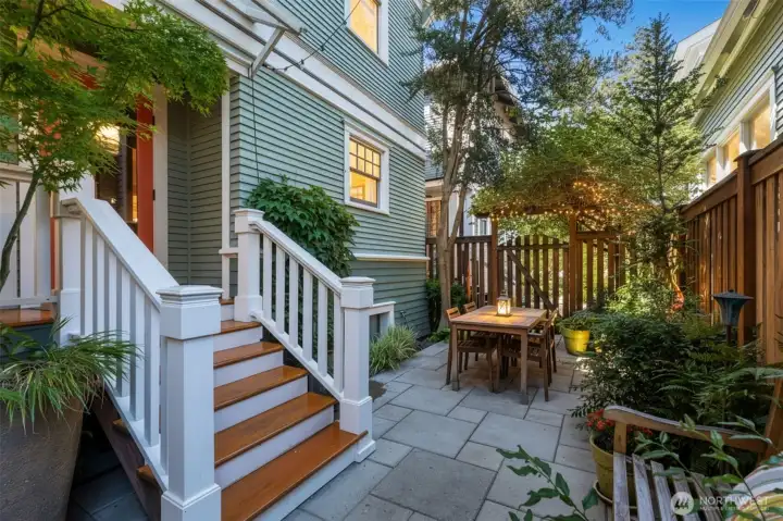 The covered back porch is just off the kitchen and is the perfect place for a grill, great for outdoor entertaining.
