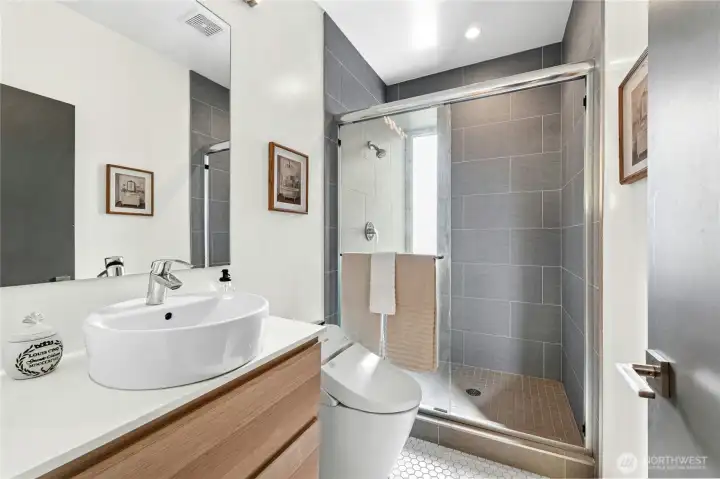 Primary bathroom with Toto Japanese bidet and shower with sitting bench.