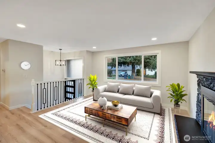 Newly remodeled from head to toe! Beautiful wrought iron railings in the living room and it is complimented by the brand new flooring and paint. virtual staging