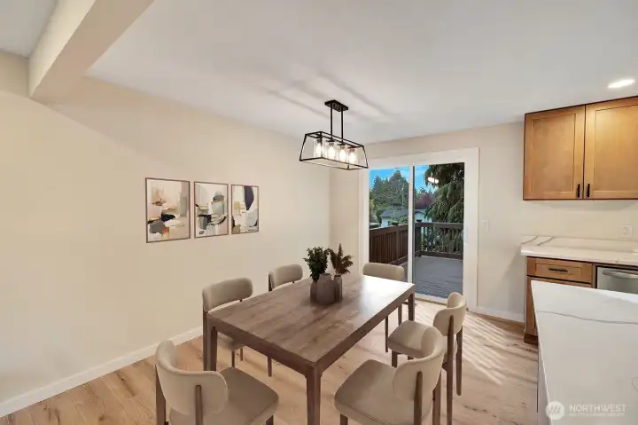 Open dining room is attached to the slider leading out to the large private deck. virtual staging
