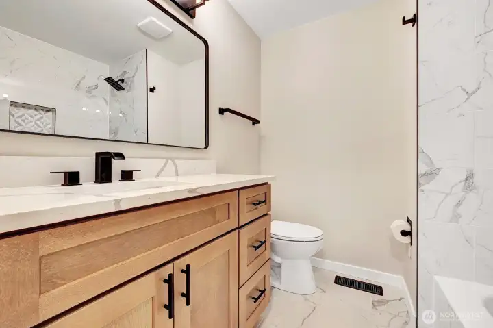 Main hallway bath is tastfully done.