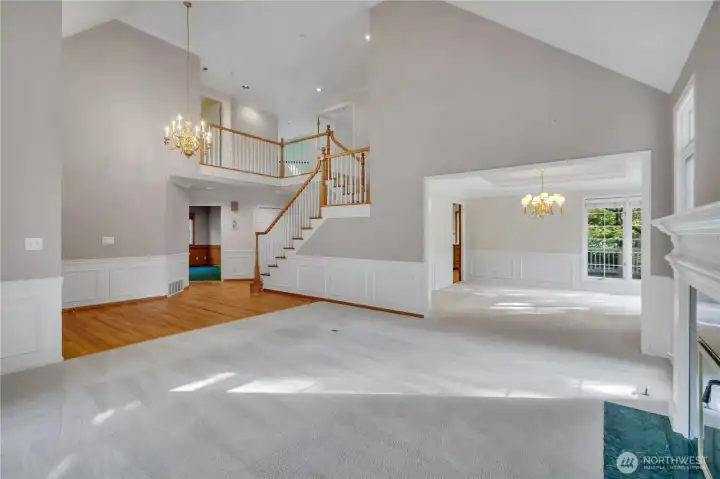 Living room view showcasing vaulted ceilings.
