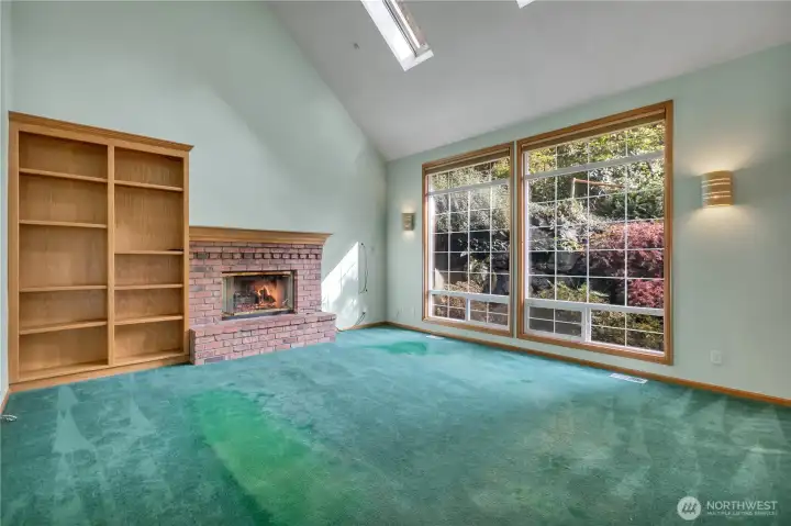 Family room with fireplace, vaulted ceiling, skylights.