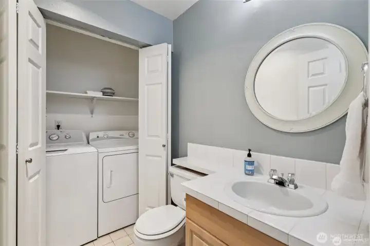 half bath with full sized washer and dryer