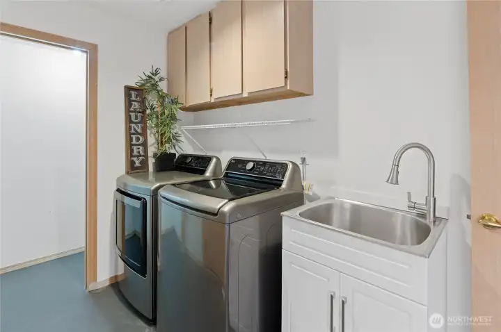 The main-level utility room is awesome with plenty of storage ~ washer & dryer stay!