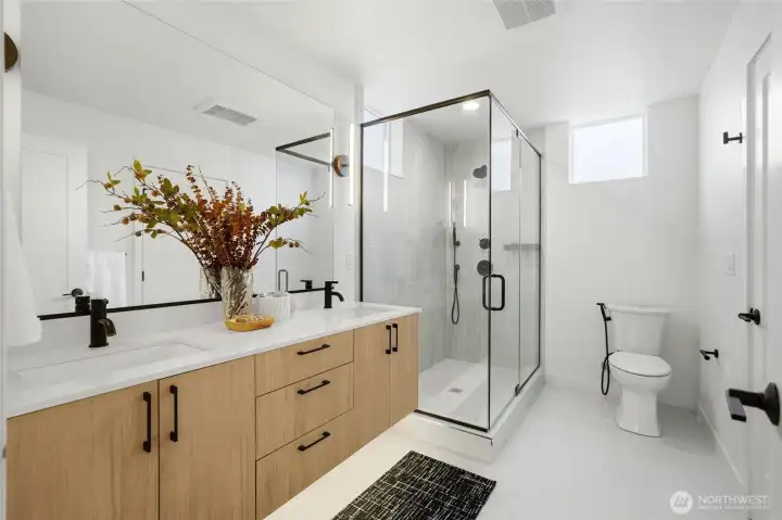 Modern bathroom with quartz vanity, contemporary fixtures, and walk-in shower.