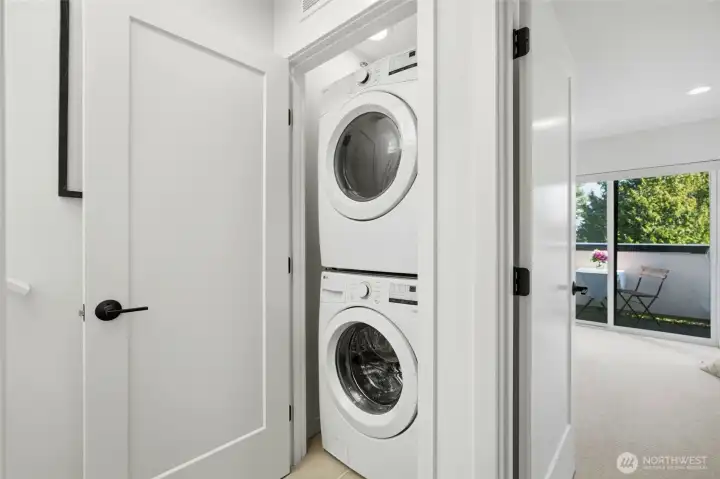 In-unit stacked washer and dryer conveniently located on the bedroom level.