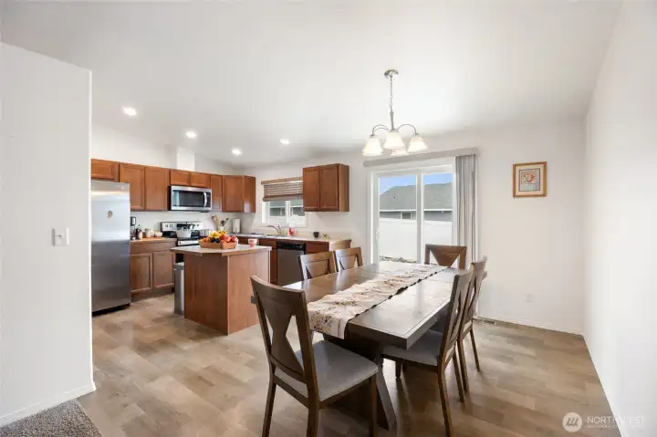 The Living room is just off the kitchen, and the living room is behind the camera.