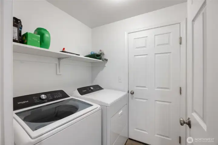 Laundry room between the garage and the hallway.