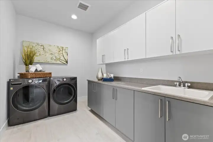 Beautifully positioned with direct access from the walk-in closet and additional hall entry, the laundry room delivers elevated utility with seamless connection to the primary suite and everyday living beyond.