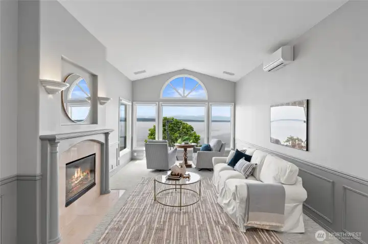 Formal living room featuring vaulted ceilings, dominating views and cozy double-sided fireplace.