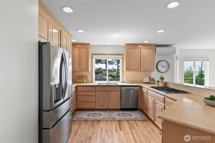 Bright kitchen with tons of counter space and loads of storage. Newer S/S appliances.