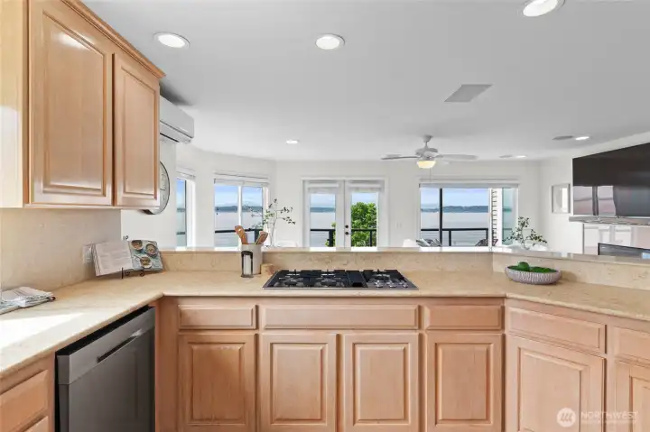 Cook and host with ease with ample counter and bar space, as you overlook sweet family room and sailboats passing by.