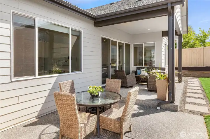 The outdoor entertaining experience extends to the back of the house where you’ll find another covered patio as well as one that is uncovered.