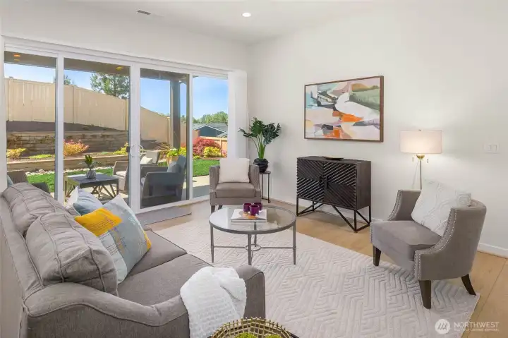 The great room boasts high ceilings and walls of windows that welcome natural light.