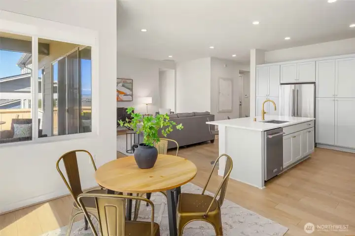 The breakfast nook sits in a sunny corner of the kitchen where you can enjoy the views outside.