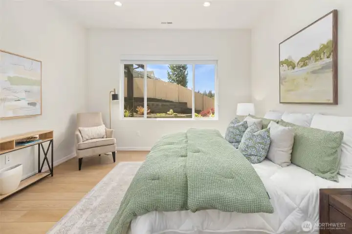 The primary suite is spacious, lofty, and bright.  It includes a proper primary bathroom and walk-in closet.