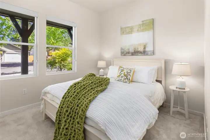 The second bedroom is located on the main level of the home, right next to the second full bathroom.