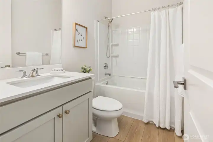 The second full bathroom on the main level supports the adjoining bedroom as well as the great room.