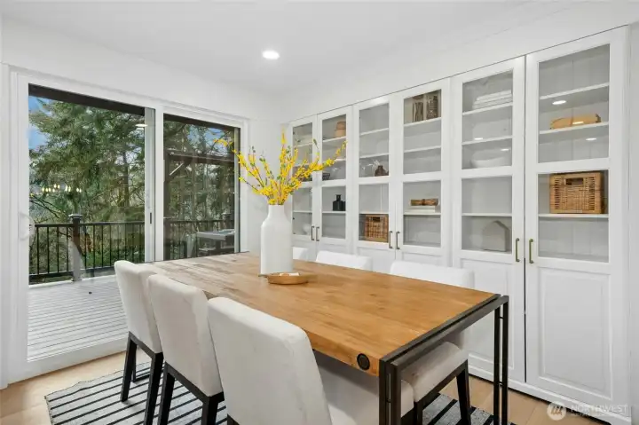 Informal dining with built-in pantry shelving accross the back wall. Informal dining with built-in pantry shelving accross the back wall.