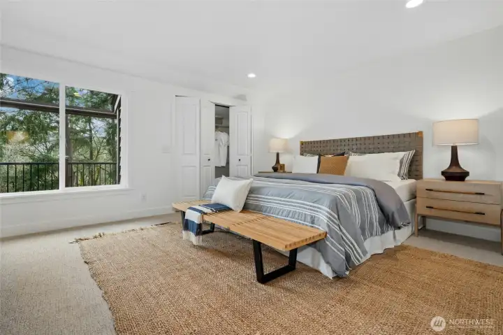 Primary bedroom upstairs with dual closets and scenic views of the outdoors. Primary bedroom upstairs with dual closets and scenic views of the outdoors.