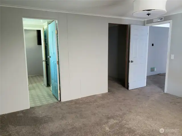 A Different View of the View of the Huge Newly Painted and Carpeted Living Room Showing the Entry Door to the Primary Master Bedroom Walk In Closet and Entry to the Primary Master Bathroom.