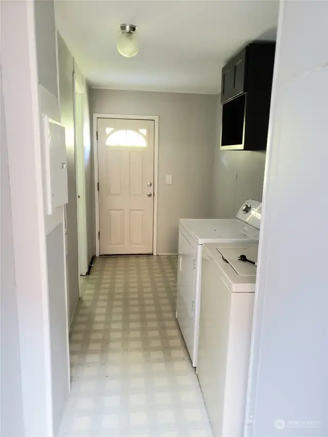 Large Utility Room with Newer Paint looking towards the Back Door.