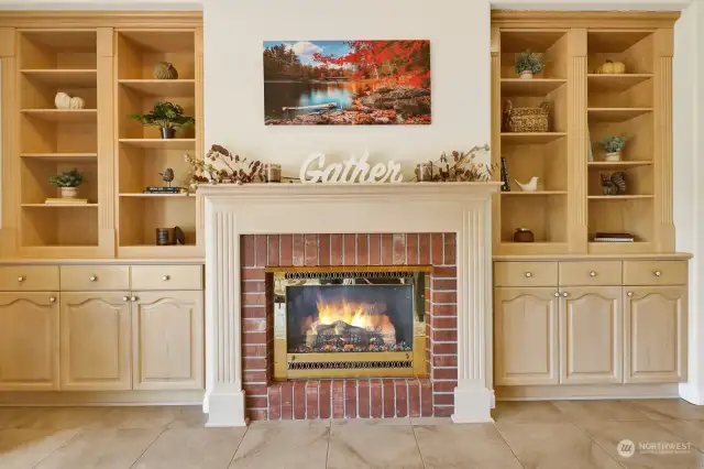 Custom built-ins frame the fireplace, offering both stylish storage and a refined look. The entire home is wired with a surround sound system, enhancing your entertainment experience throughout every room.