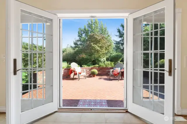 Step through the French doors to enjoy the charming custom brick patio, perfect for outdoor relaxation and entertaining.