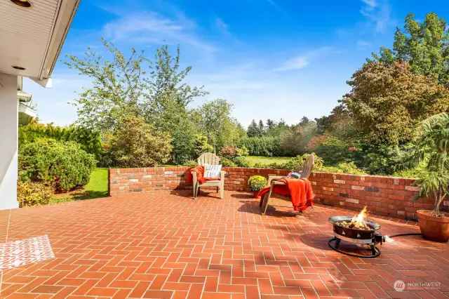 This incredible space, accessed from the family room, is enclosed by a brick wall and a fenced patio on the side of the home. Picture yourself enjoying a cozy autumn evening around the firepit!