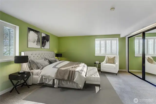 Plantation shutters accent both windows in the king-size primary suite.