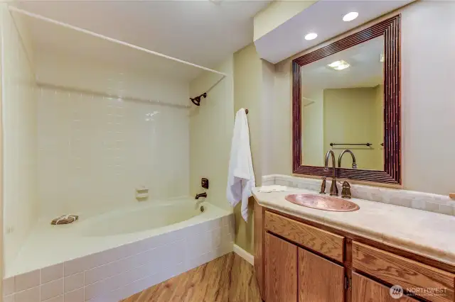 Copper sink and soaking tub with gentle back are both lovely additions to the primary bath.