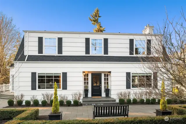 Nestled on an expansive 16,200 sq. ft. west-facing corner lot in Clyde Hill, this stunning Dutch Colonial blends traditional charm with modern sophistication