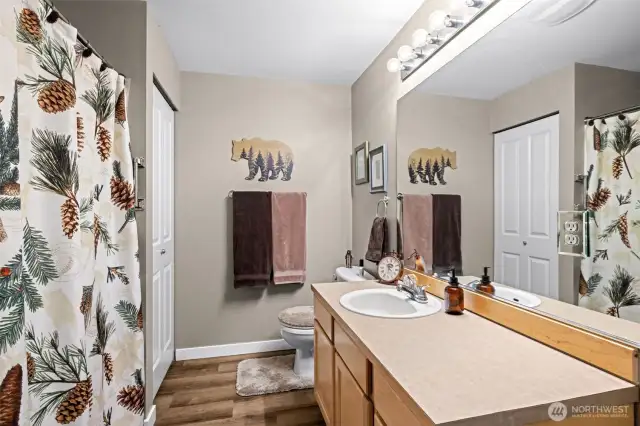 The guest bath features a full tub and shower, plus a spacious countertop with plenty of room for all the daily essentials.